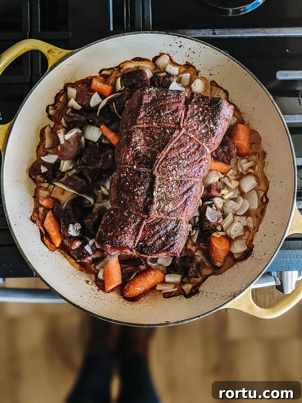 Tender Slow-Roasted Eye Round: Juicy, Melts in Your Mouth 6 Roast taken out of the oven with browned veggies beneath it.