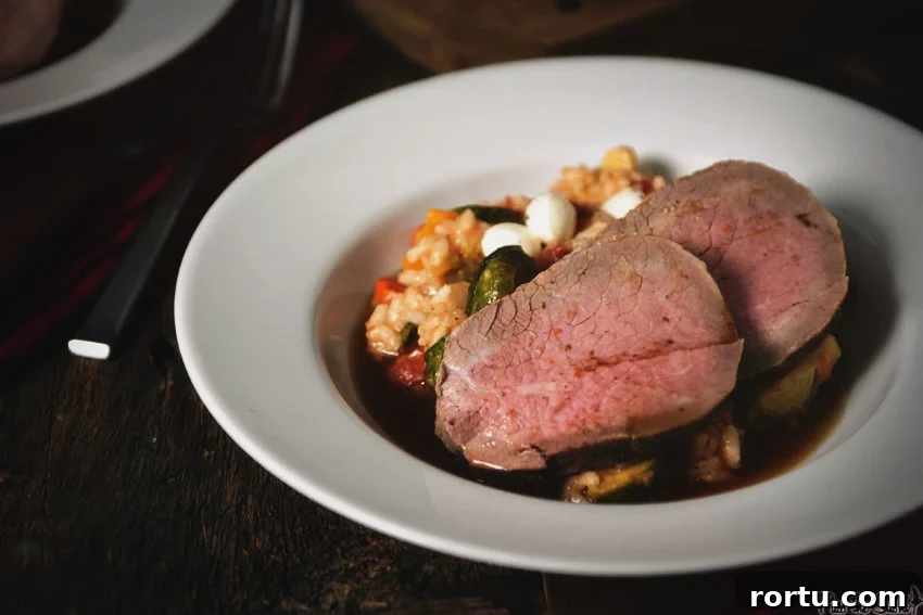 Tender Slow-Roasted Eye Round: Juicy, Melts in Your Mouth 8 Two slices of eye of round roast over a fall roasted veggie risotto