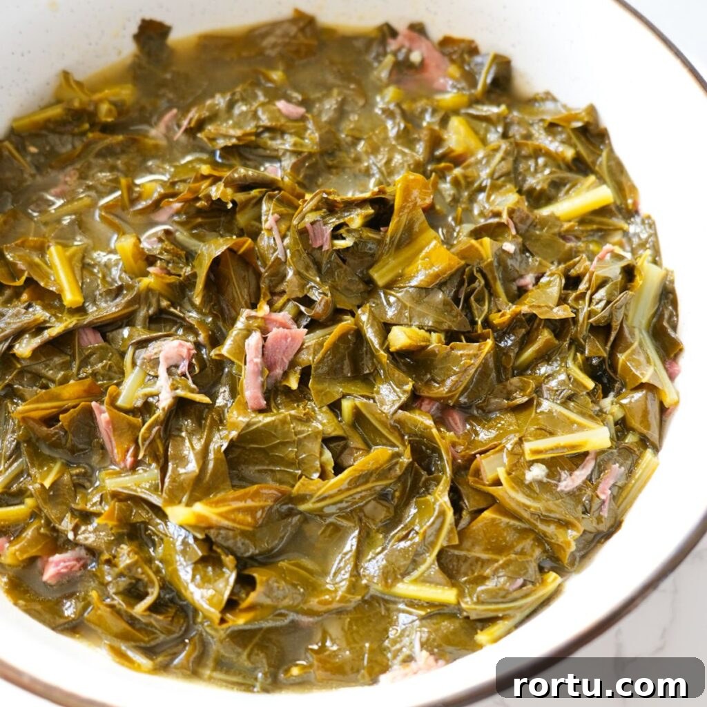 Authentic Southern Collard Greens Recipe for Soul Food Fans 2 Tender soul food collard greens with smoked meat and savory broth.