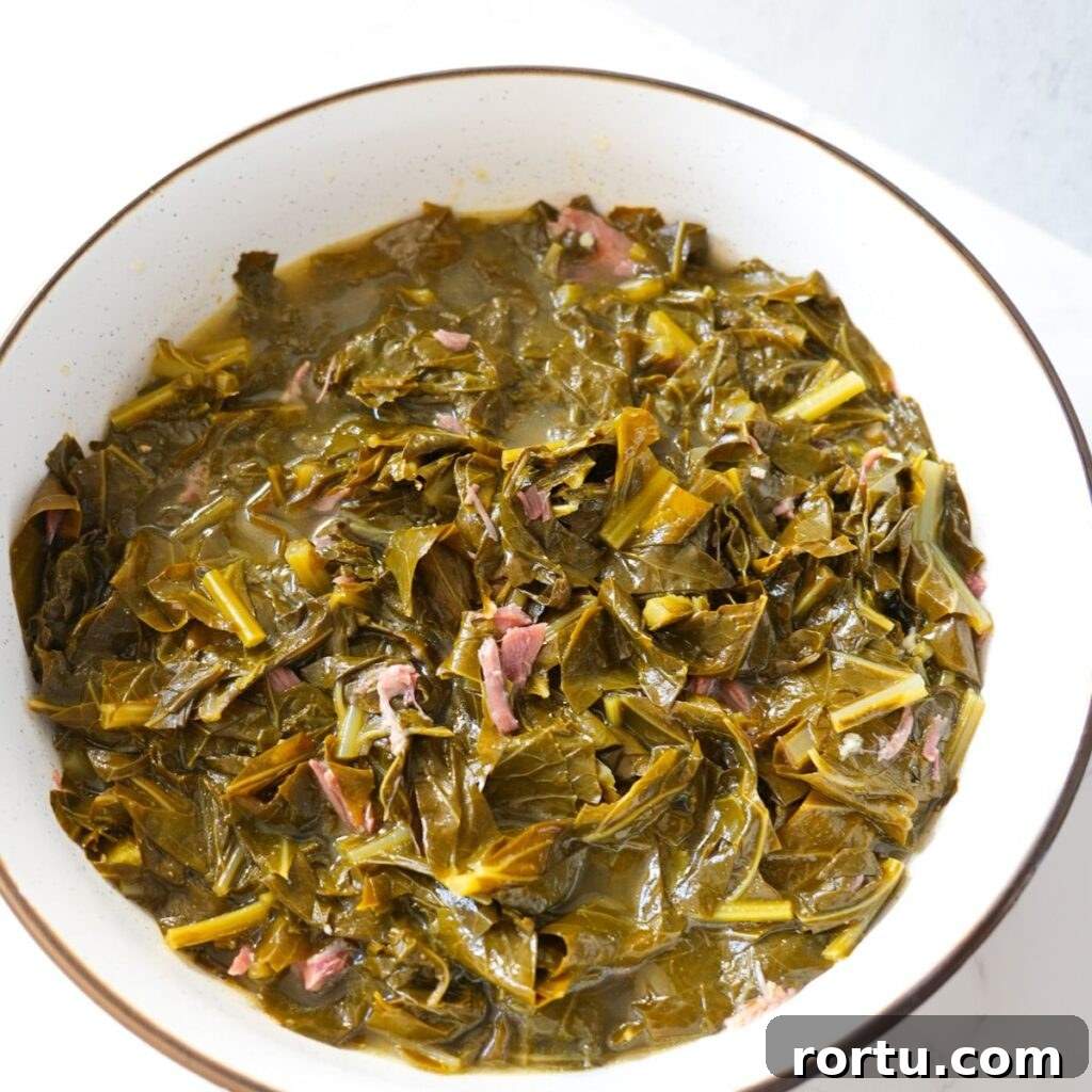 Authentic Southern Collard Greens Recipe for Soul Food Fans 11 Tender soul food collard greens with smoked meat and savory broth.