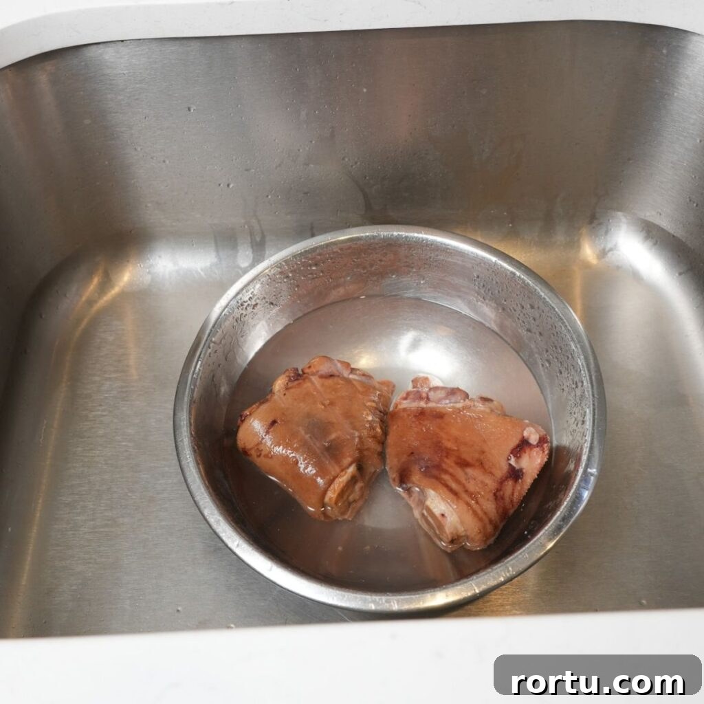 Authentic Southern Collard Greens Recipe for Soul Food Fans 6 Ham hocks in a bowl with water and vinegar.