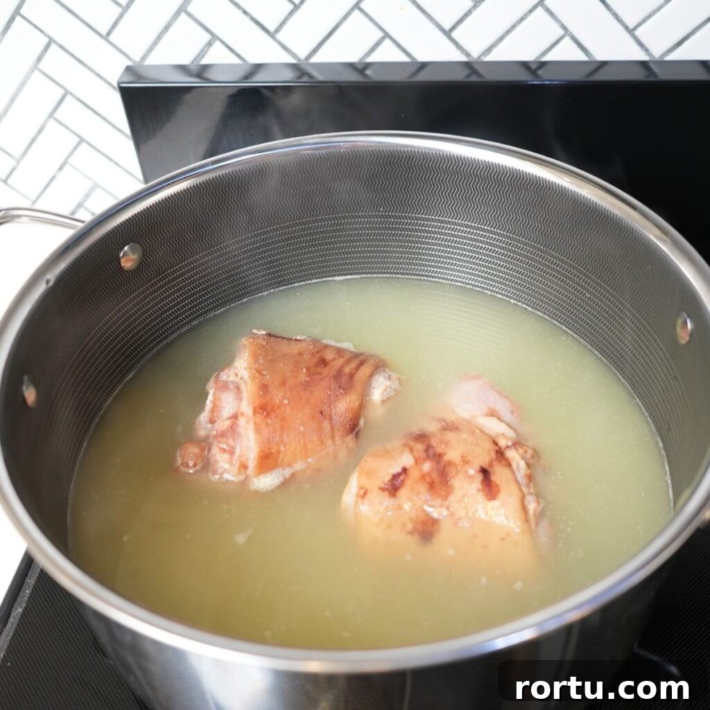 Authentic Southern Collard Greens Recipe for Soul Food Fans 7 Ham hocks simmering in chicken broth.