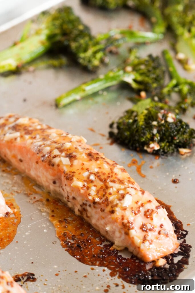 Maple Mustard Baked Salmon Recipe for Tender Glazed Fillets 4 maple dijon glazed salmon fillet on a baking sheet