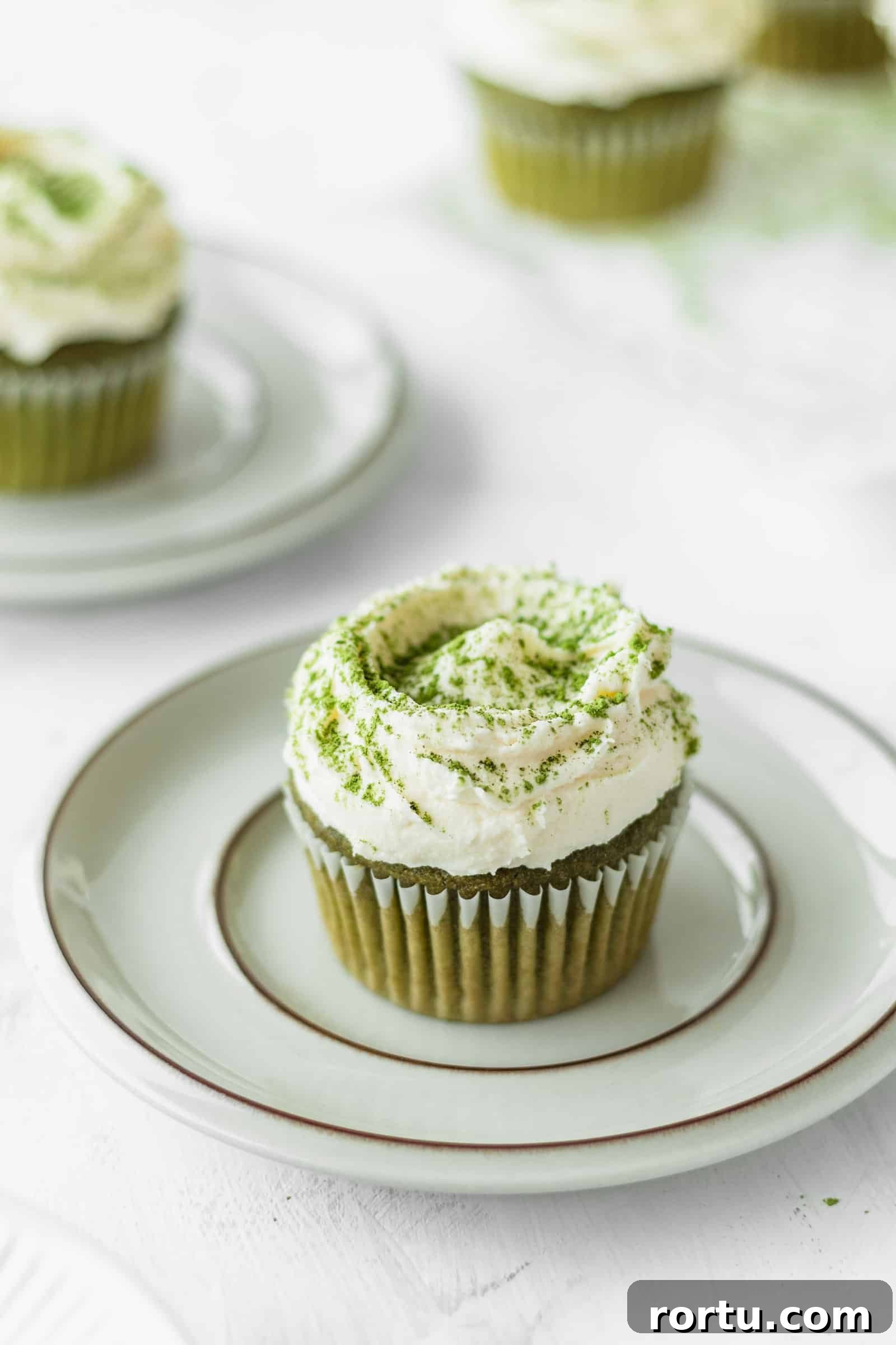 Fluffy Matcha Cupcakes: How to Make Moist Green Tea Cupcakes (Video) 2 Matcha cupcake on a plate