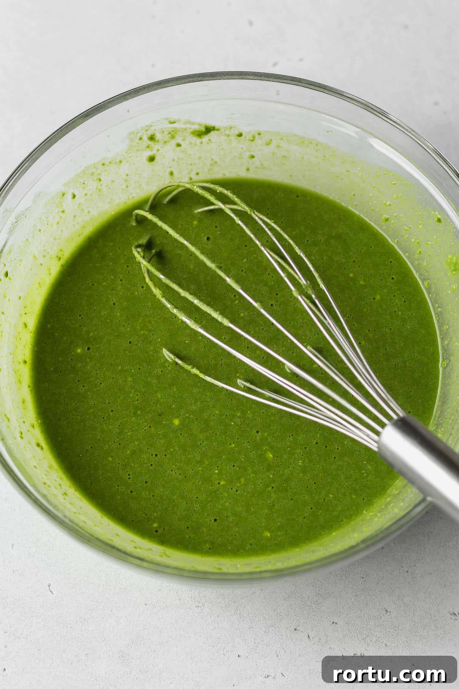 Fluffy Matcha Cupcakes: How to Make Moist Green Tea Cupcakes (Video) 5 Bowl of matcha cake batter with a whisk