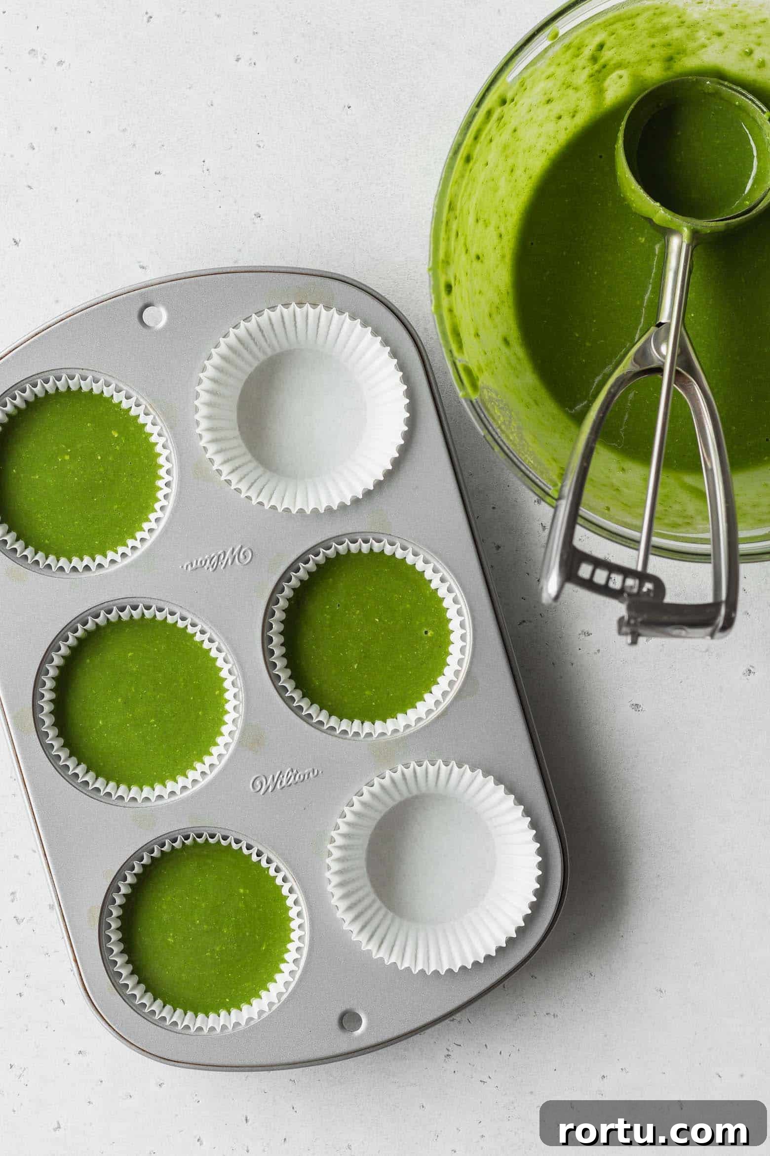 Fluffy Matcha Cupcakes: How to Make Moist Green Tea Cupcakes (Video) 6 Pour the matcha cake batter into the muffin pan using an ice cream scoop