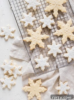 decorated snowflake sugar cookies on cooling.