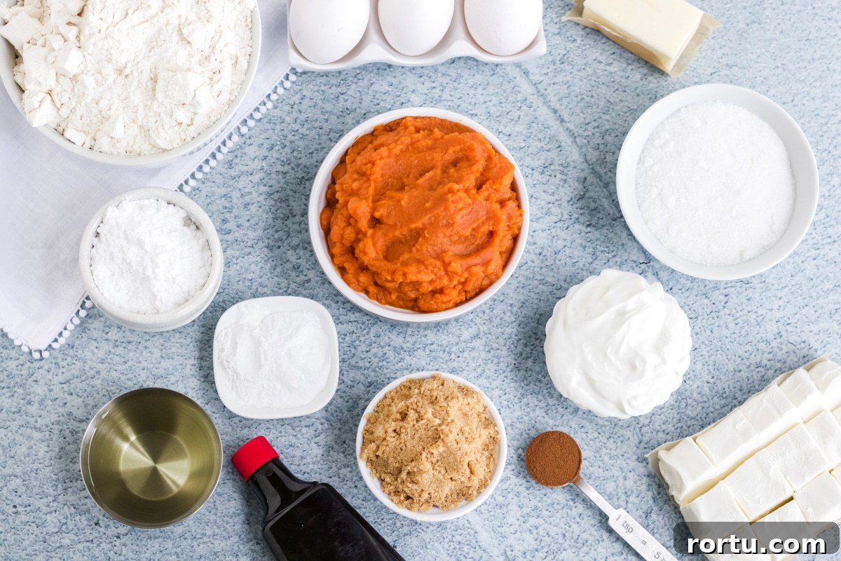 Ingredients for pumpkin cream cheese cake on the table before mixing together.
