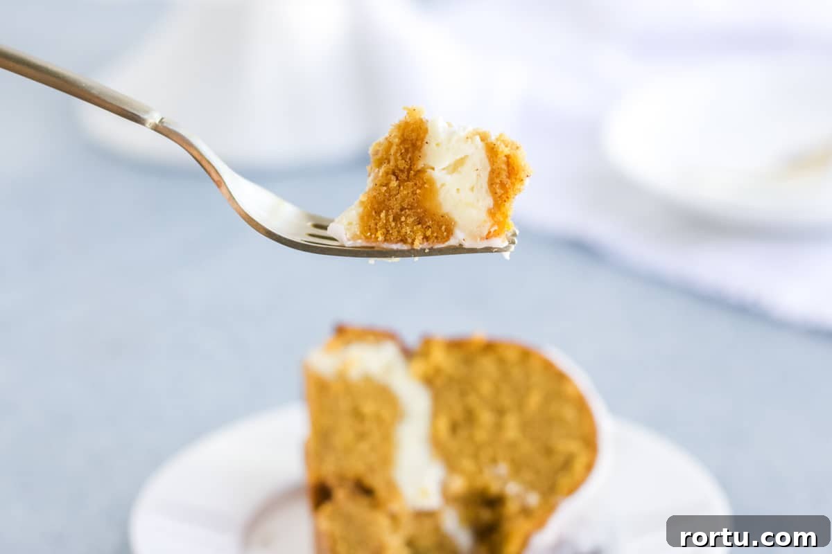 A bite of pumpkin cream cheese pound cake on a fork.