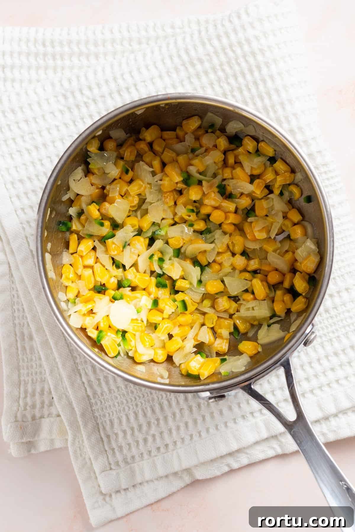 Spicy Jalapeño Corn Salad Bowl 5 An overhead image of corn kernels added to the saucepan.