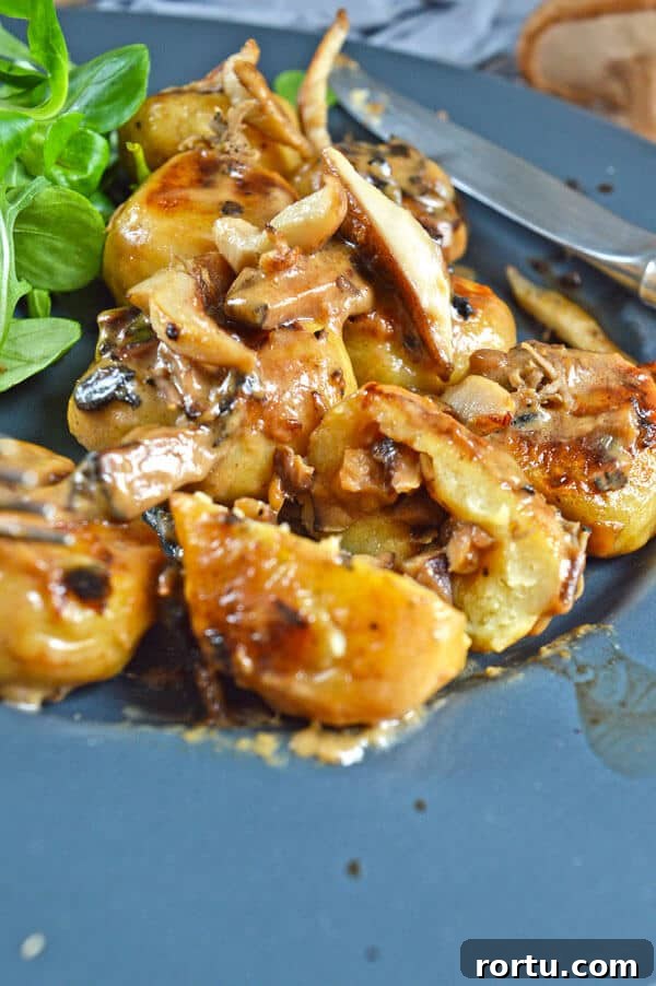 Sliced open brown gnocchi with a brown filling on a grey plate