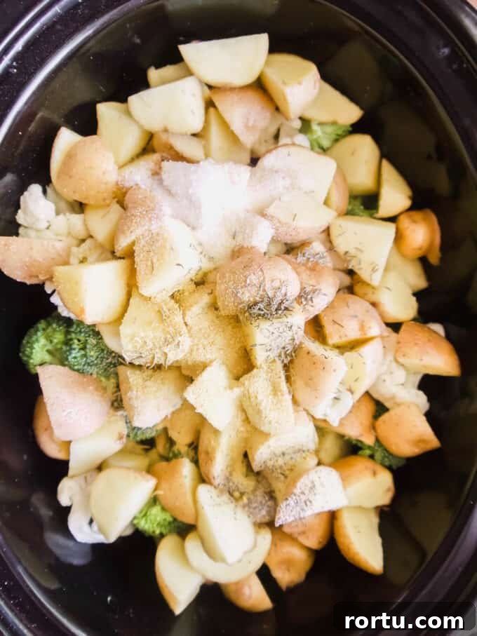 Slow Cooker Chicken Pot Pie Soup — Whole30, Paleo, Dairy-Free 5 Potatoes with coconut cream and herbs added to the slow cooker.