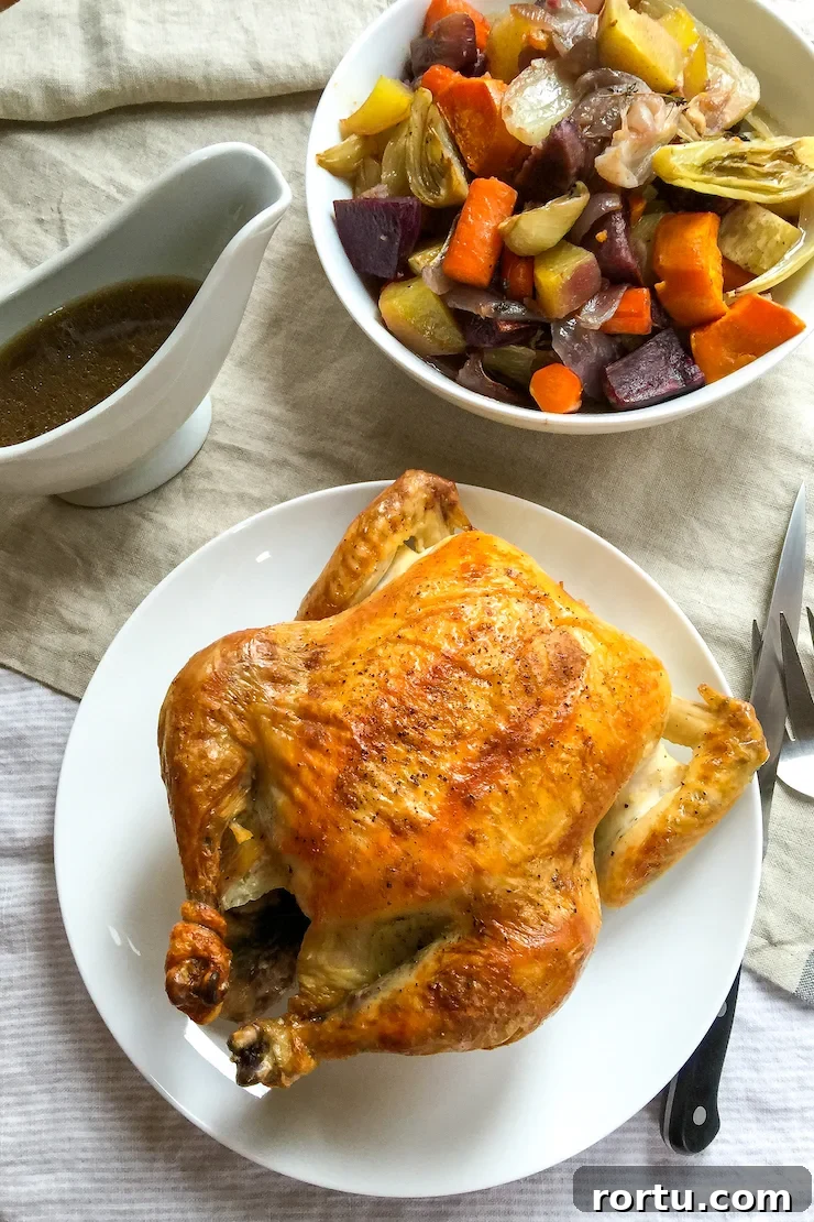 Crisp Roast Chicken with Honey-Glazed Root Vegetables 5 Roast chicken on tables with vegetables and pan juices.