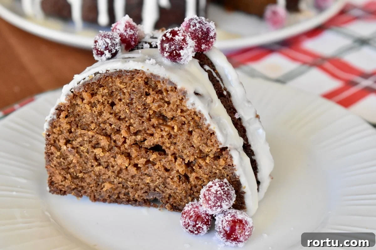 Maple-Glazed Gingerbread Bundt Cake Recipe for Holiday Baking 3 Slice of gingerbread bundt cake on a white plate.