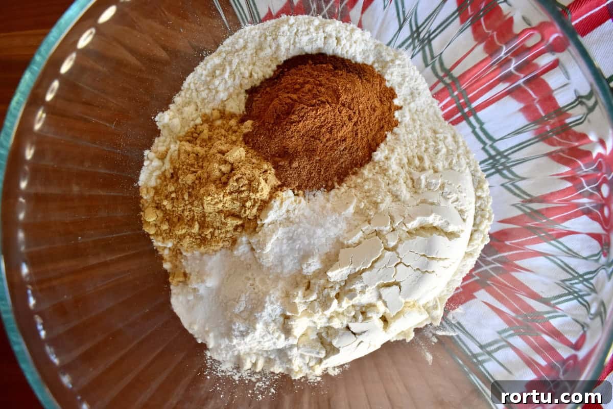 Maple-Glazed Gingerbread Bundt Cake Recipe for Holiday Baking 5 Dry ingredients in a glass bowl.