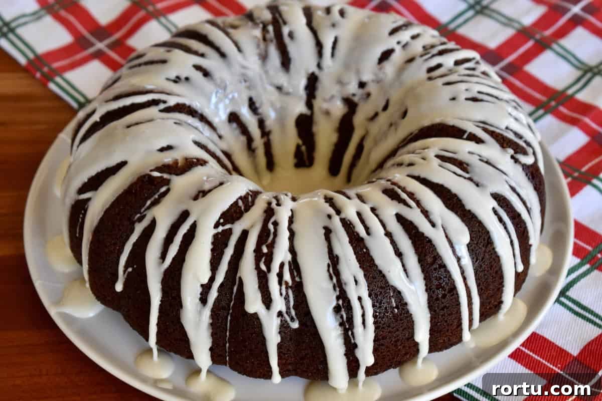Maple-Glazed Gingerbread Bundt Cake Recipe for Holiday Baking 8 Glazed poured over gingerbread bundt cake.