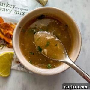 Spoon of gravy with a Turkey Gravy Packet lemon garlic and herb