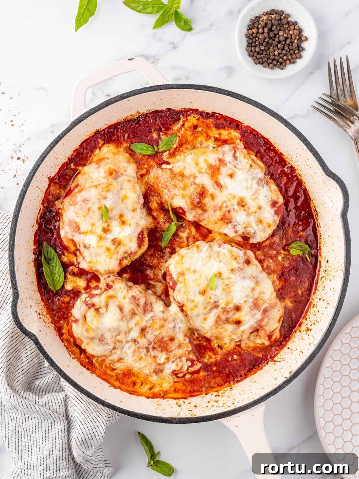 Overhead view of a pan with chicken parmesan.