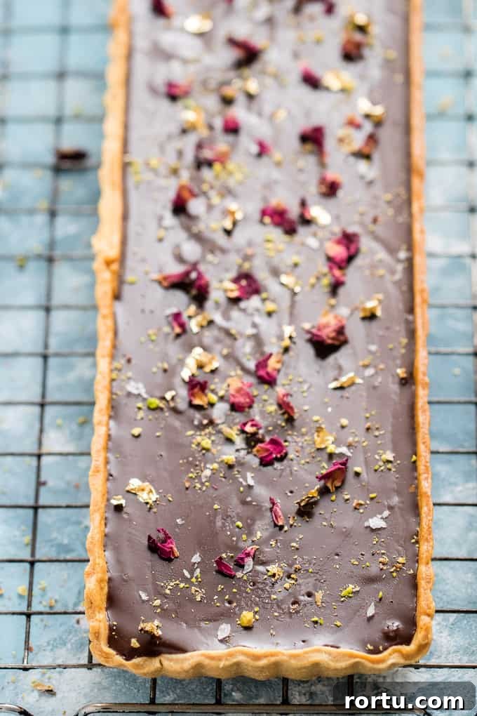 This is the creamiest dreamiest chocolate truffle tart that you will ever eat. Dark smooth chocolate, in a crispy flaky crust, topped with hazelnuts.