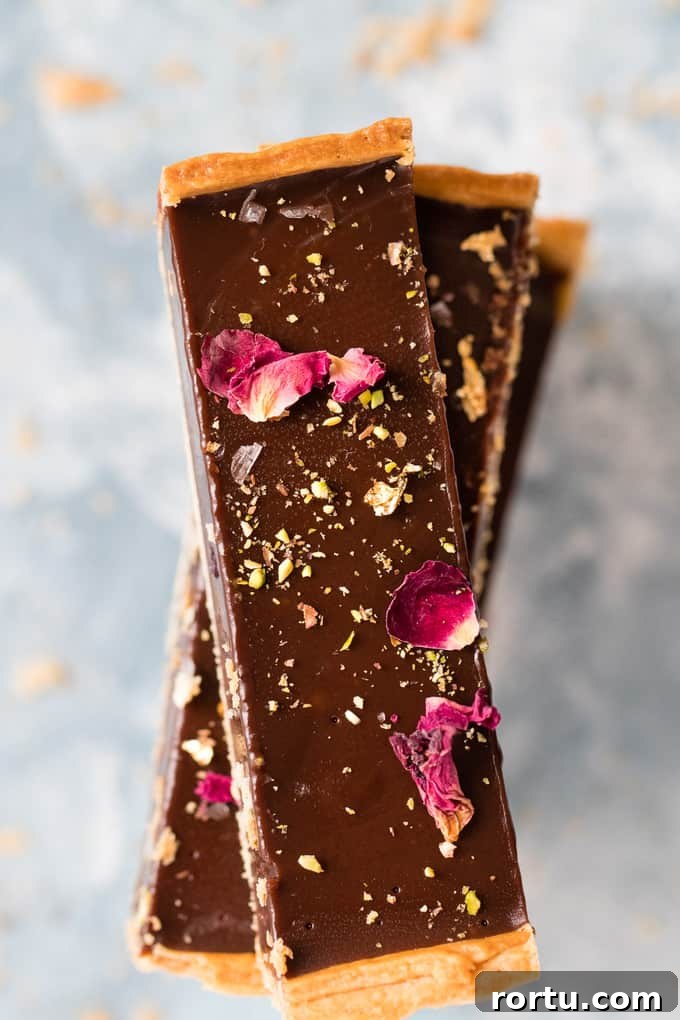 This is the creamiest dreamiest chocolate truffle tart that you will ever eat. Dark smooth chocolate, in a crispy flaky crust, topped with hazelnuts.