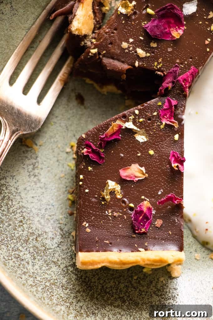 This is the creamiest dreamiest chocolate truffle tart that you will ever eat. Dark smooth chocolate, in a crispy flaky crust, topped with hazelnuts.