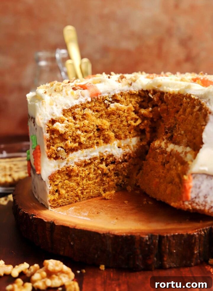 Ultimate Carrot Cake with Light Fluffy Cream Cheese Frosting 2 best carrot cake recipe sliced on wooden plank