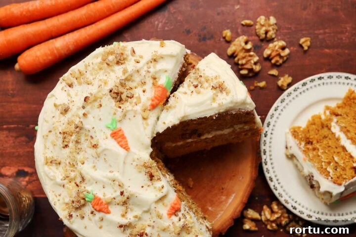 Ultimate Carrot Cake with Light Fluffy Cream Cheese Frosting 16 best carrot cake sliced on cutting board