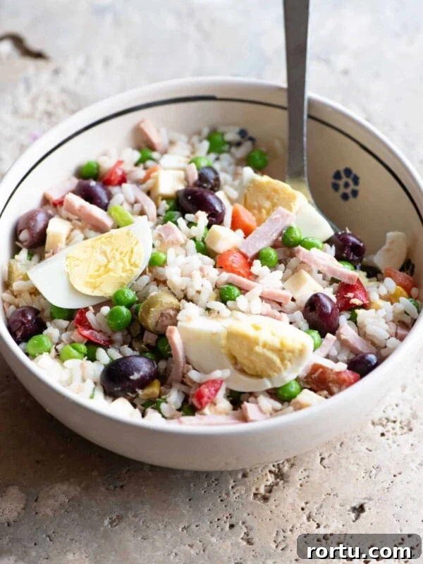 Grilled Summer Vegetables Orzo Salad with Lemon Herb Dressing 6 A traditional Italian rice salad in a bowl sitting on a rustic stone work top.