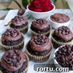 Chocolate muffins with chocolate frosting on top.