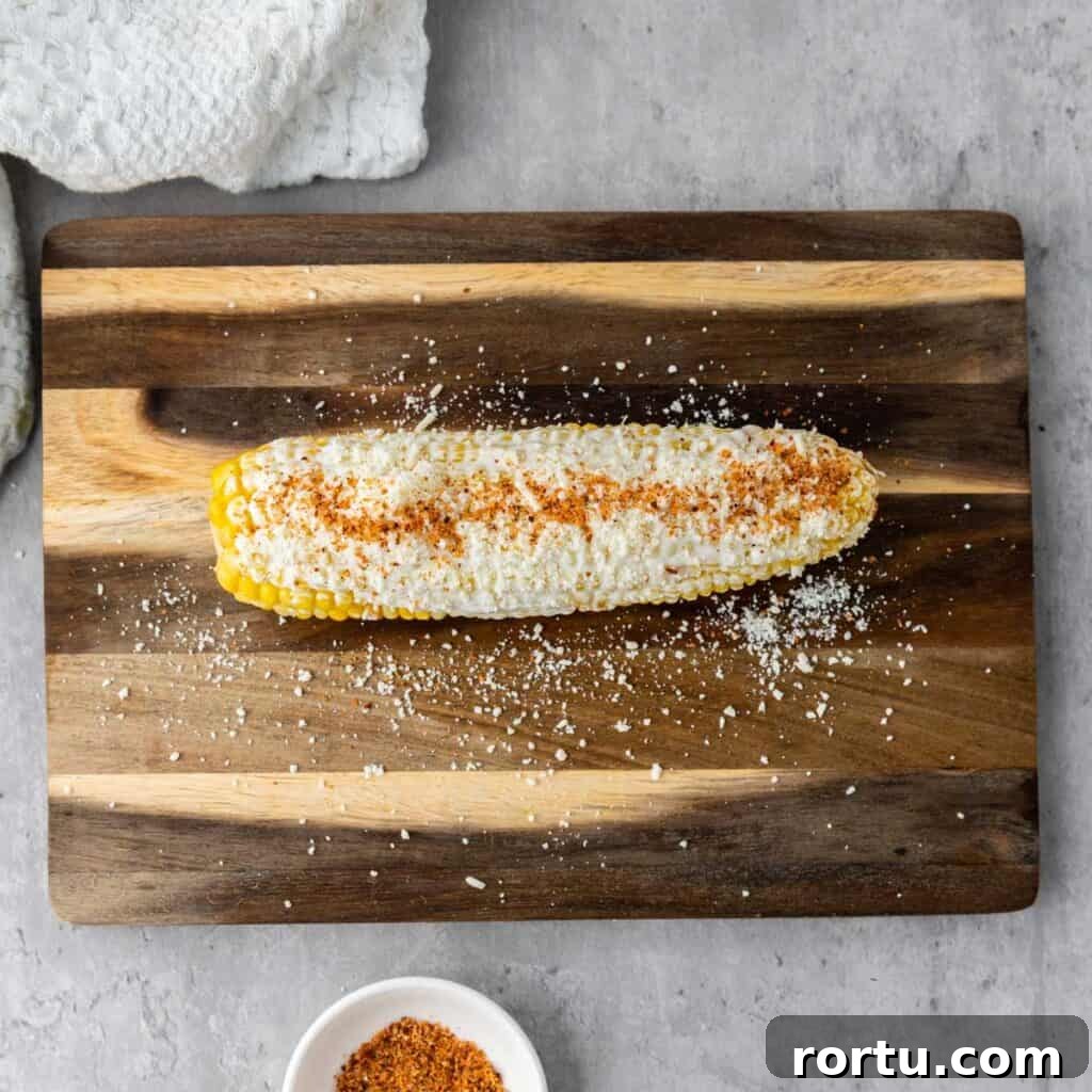 corn cob with mayonnaise, cotija cheese, and chili powder
