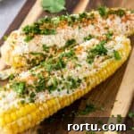 Mexican elotes on wooden cutting board