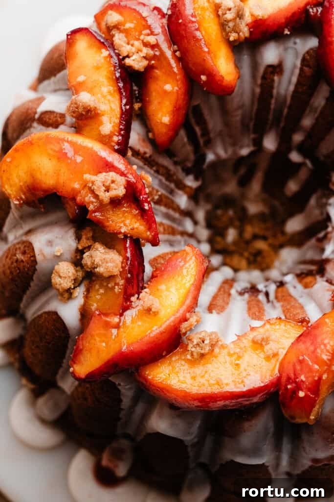 Roasted peach slices on top of a peach cobbler pound cake.