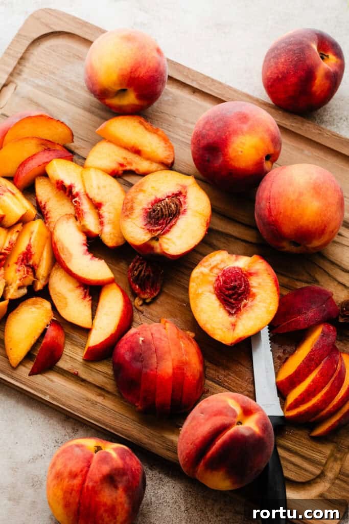 Sliced peaches on a cutting board.