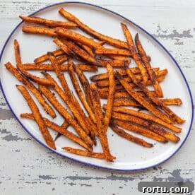 Sweet potato fries on white plate.