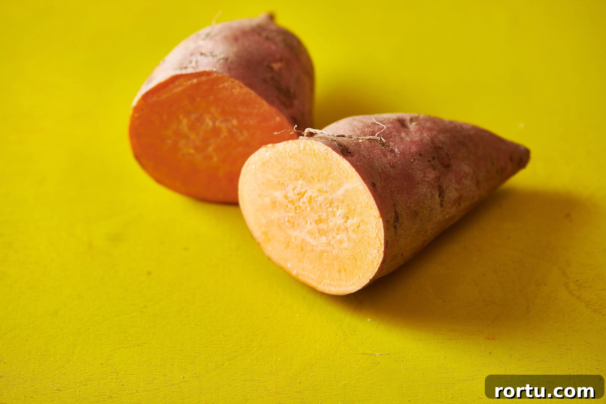 One sweet potato cut in half.