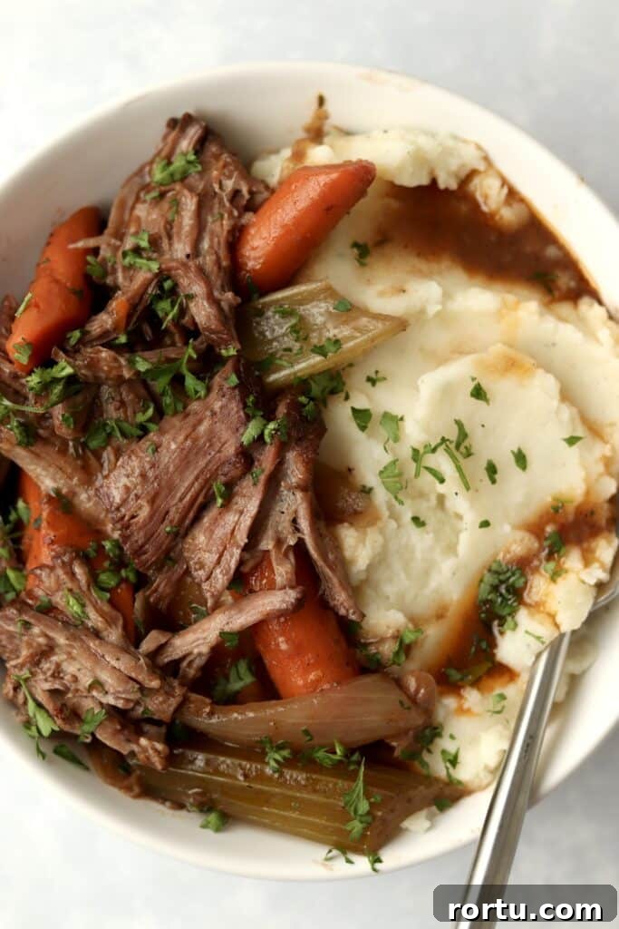 close up of slow cooker pot roast and gravy in bowl