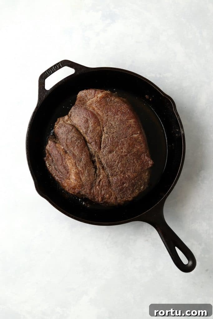 Browned chuck roast in cast iron skillet