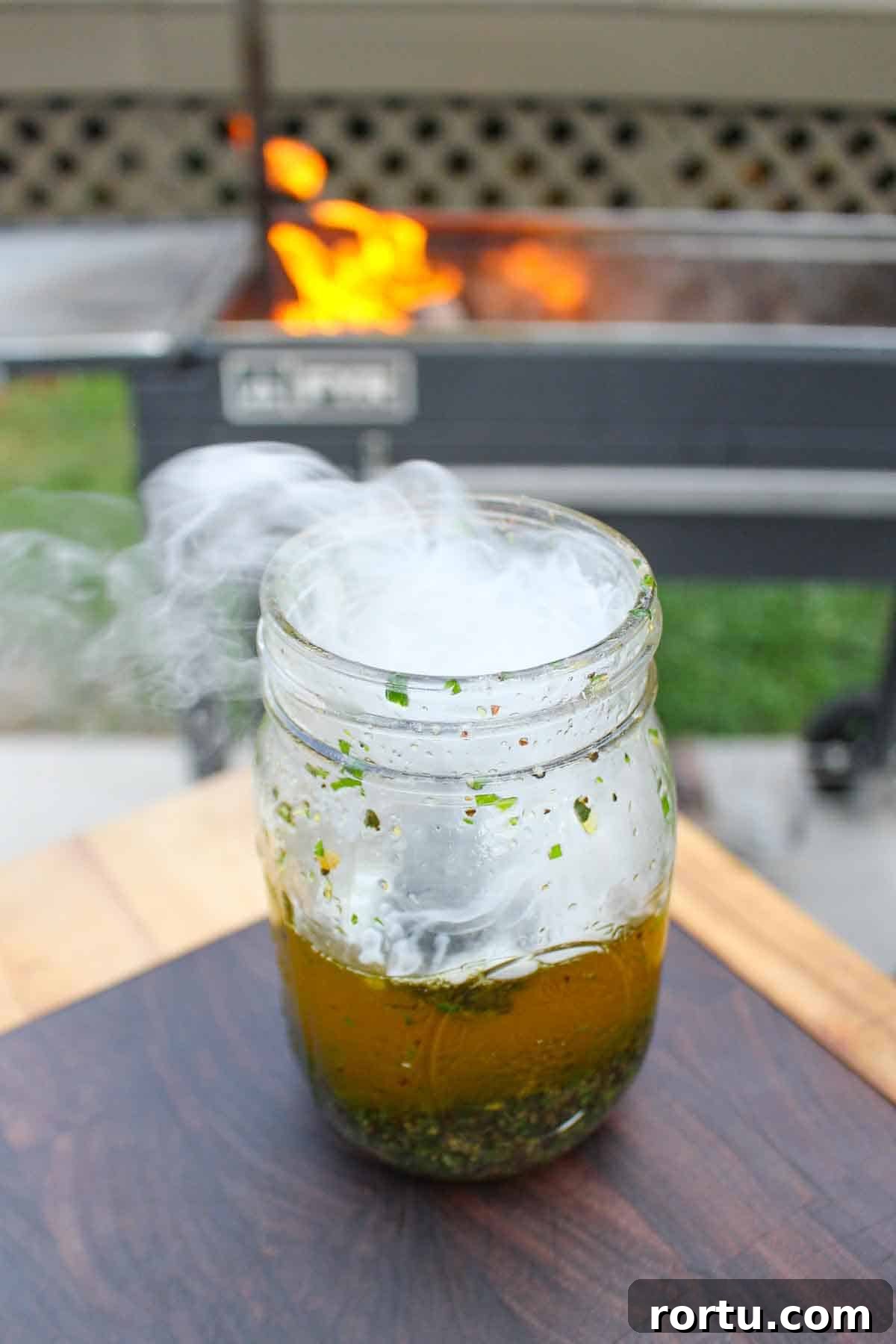 Smoke flowing out of the mason jar containing the compound butter. 