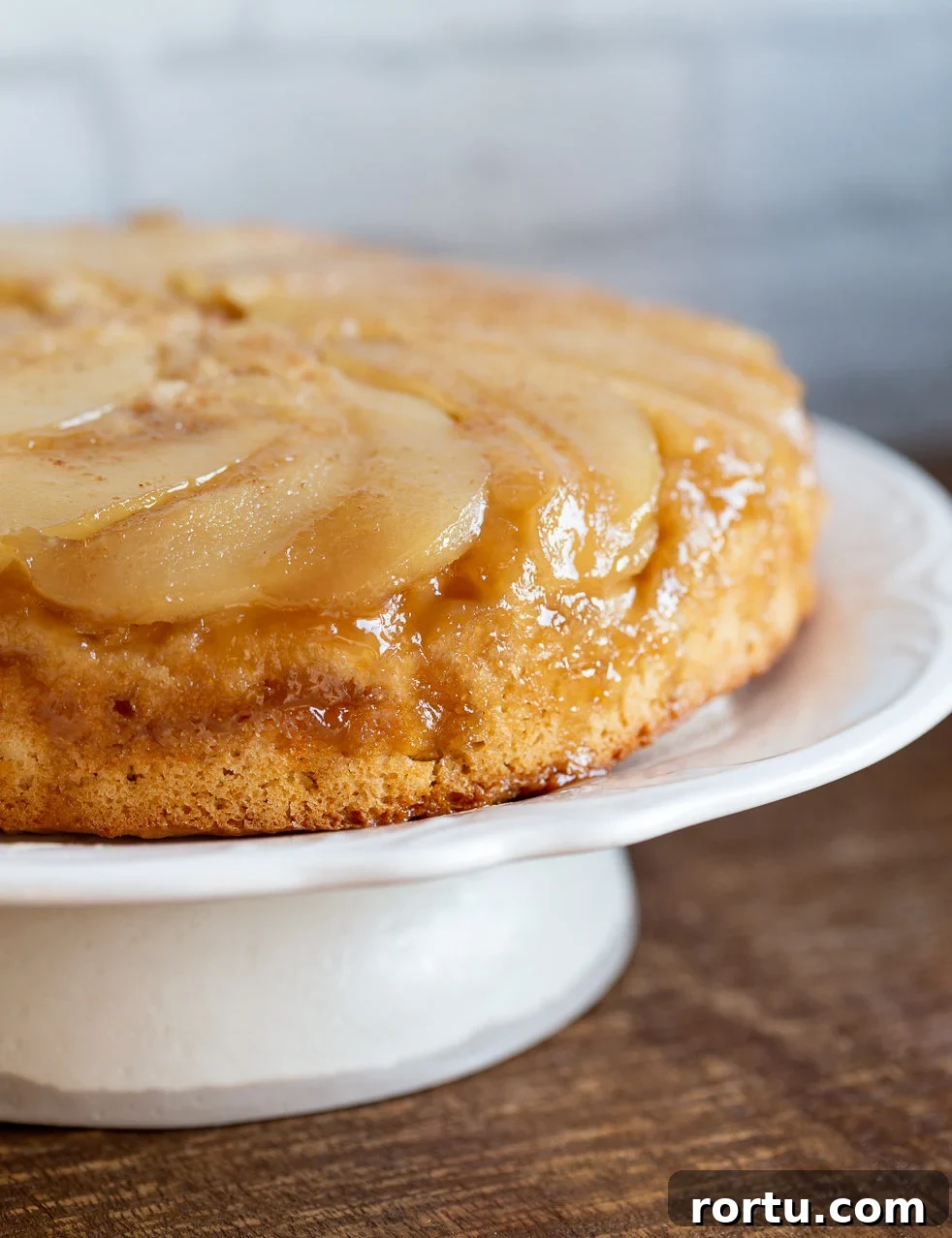 Moist Vegan Pear Upside-Down Cake Recipe 3 Our Vegan Pear Upside Down Cake on a white cake stand