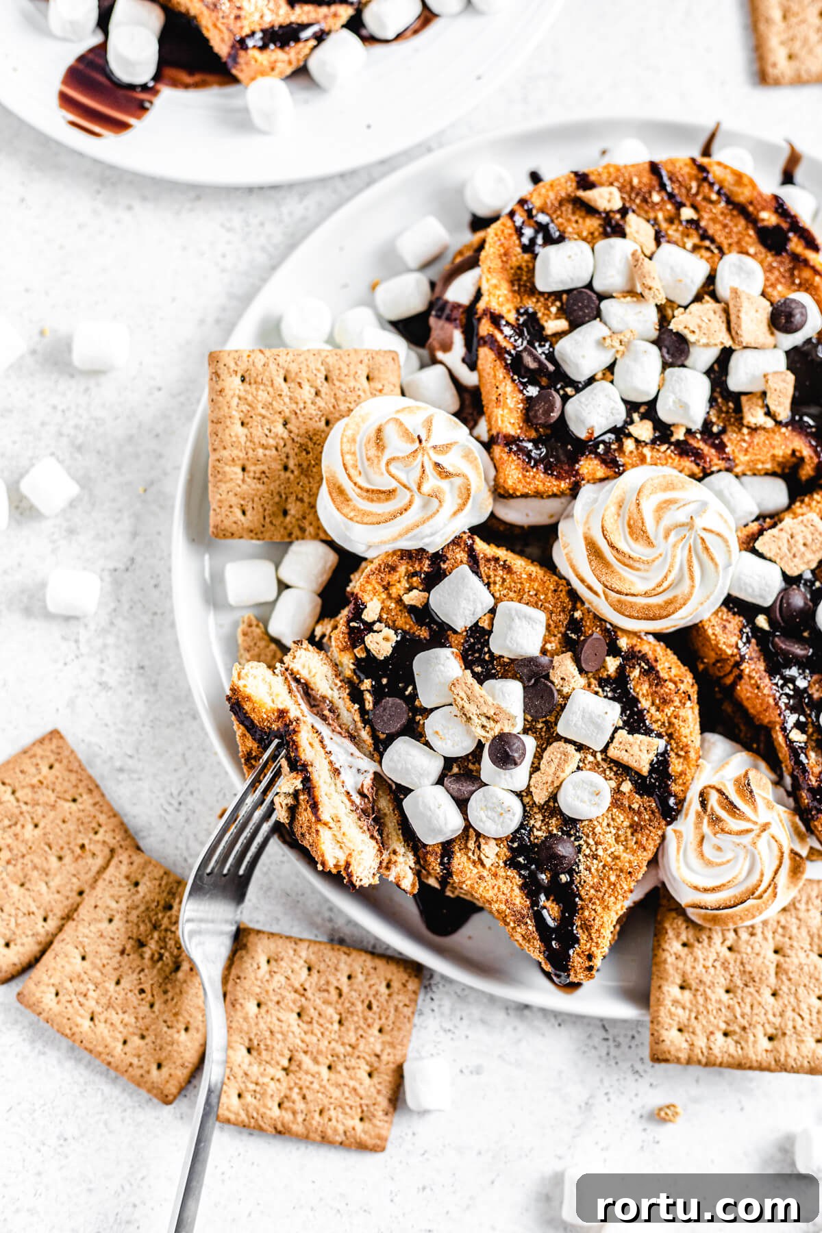French toast on a white platter with a piece taken off of one