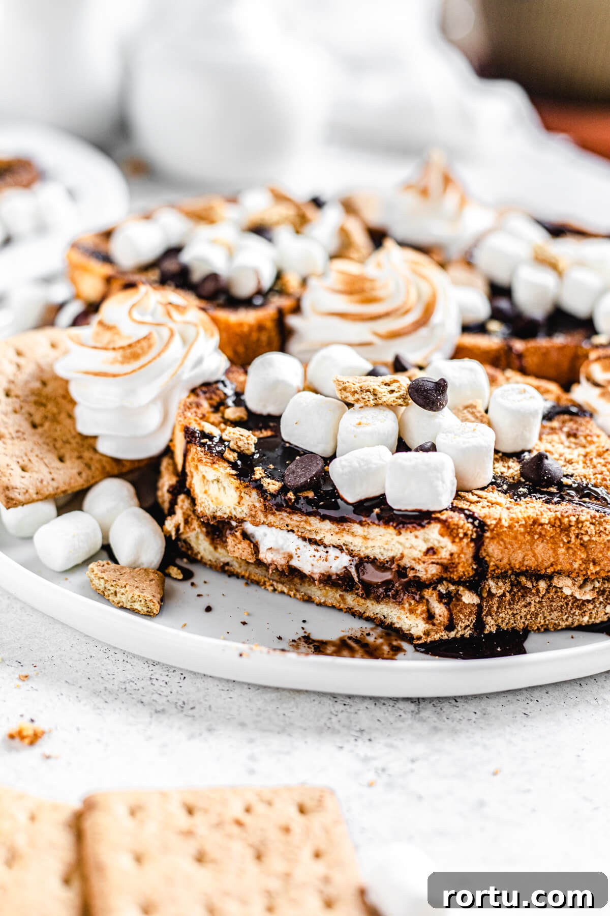 French toast on a plate with bite removed to show chocolate marshmallow filling