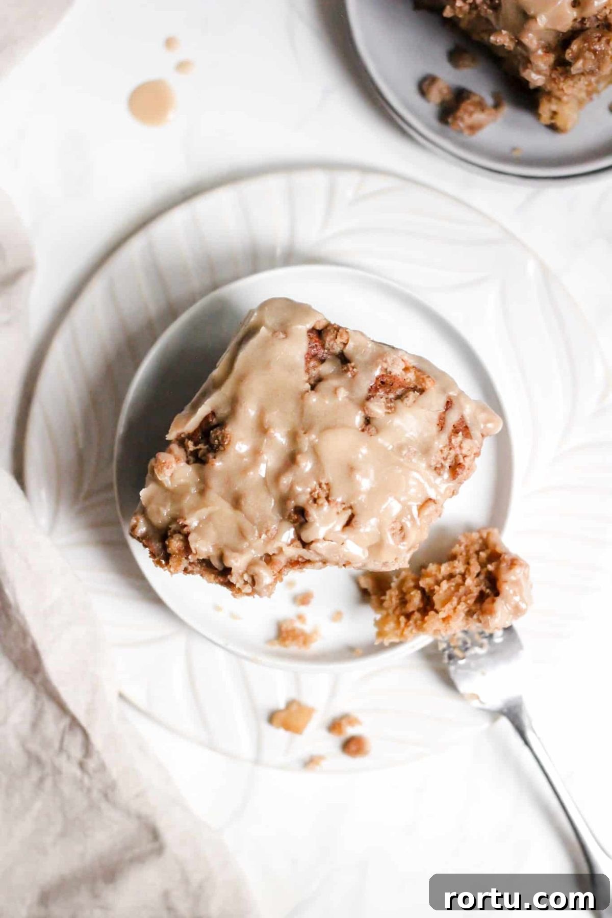 Slice of Healthier Breakfast Apple Cake with Crumble Topping and Maple Glaze