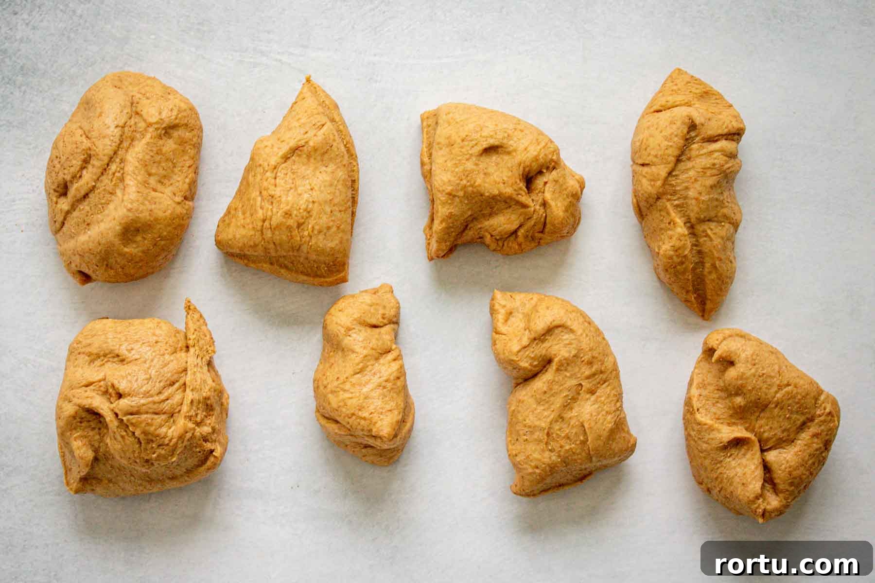 Quick Whole-Wheat Dinner Rolls That Rise Perfectly 8 Dough portioned into 8 pieces.