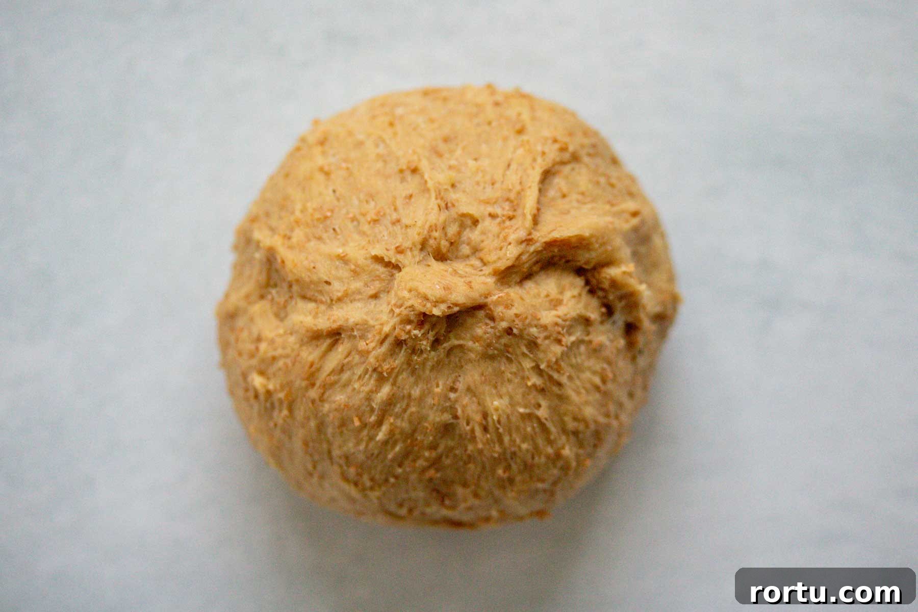 Quick Whole-Wheat Dinner Rolls That Rise Perfectly 9 Ball shaped dough.