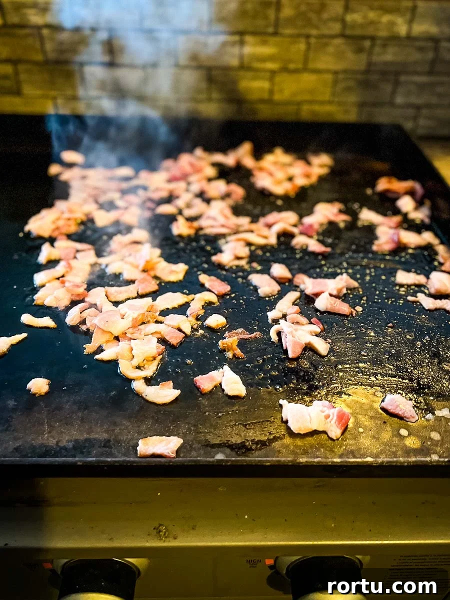bacon cooking on the griddle.