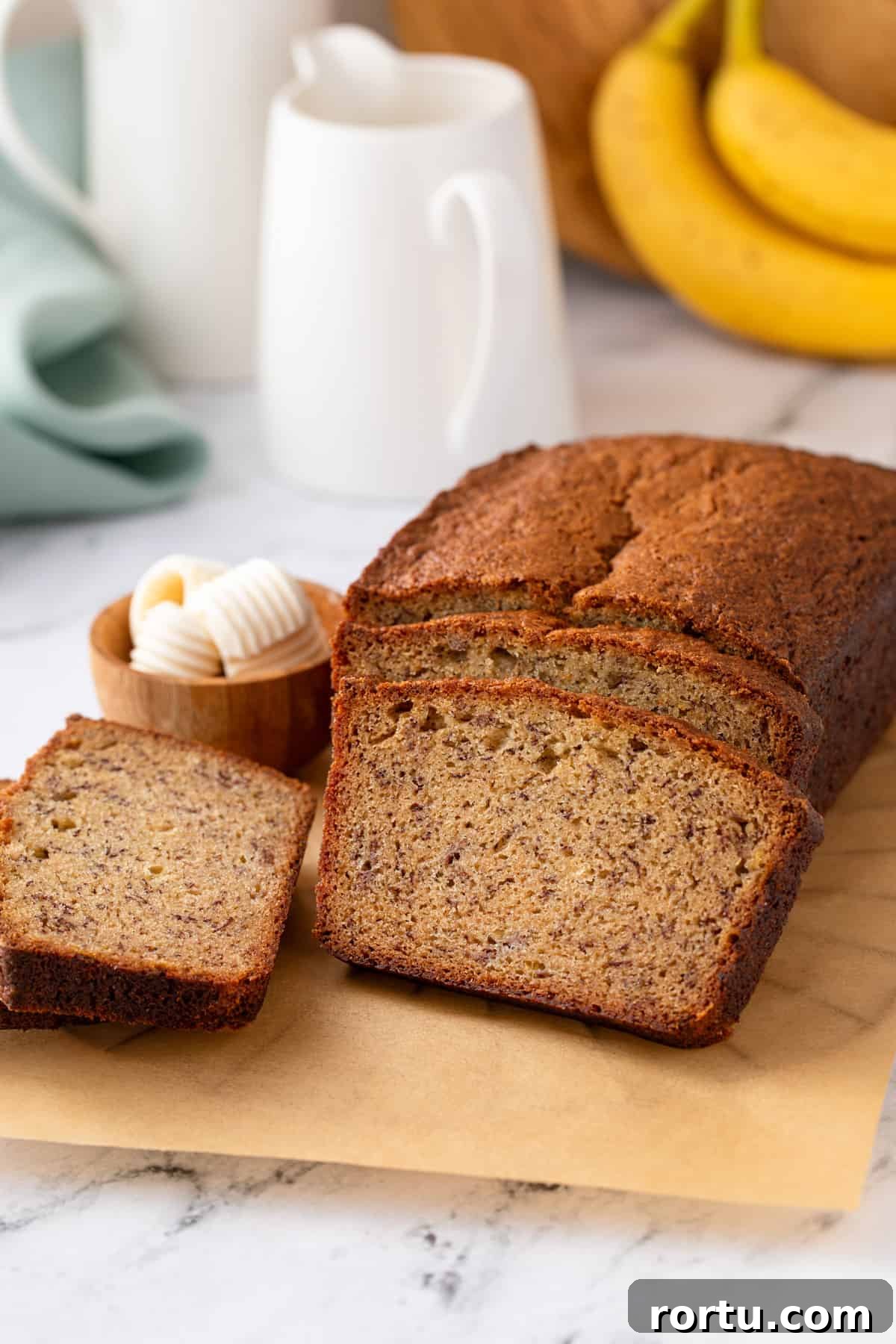 Loaf of dominique ansel's banana bread cut into slices.