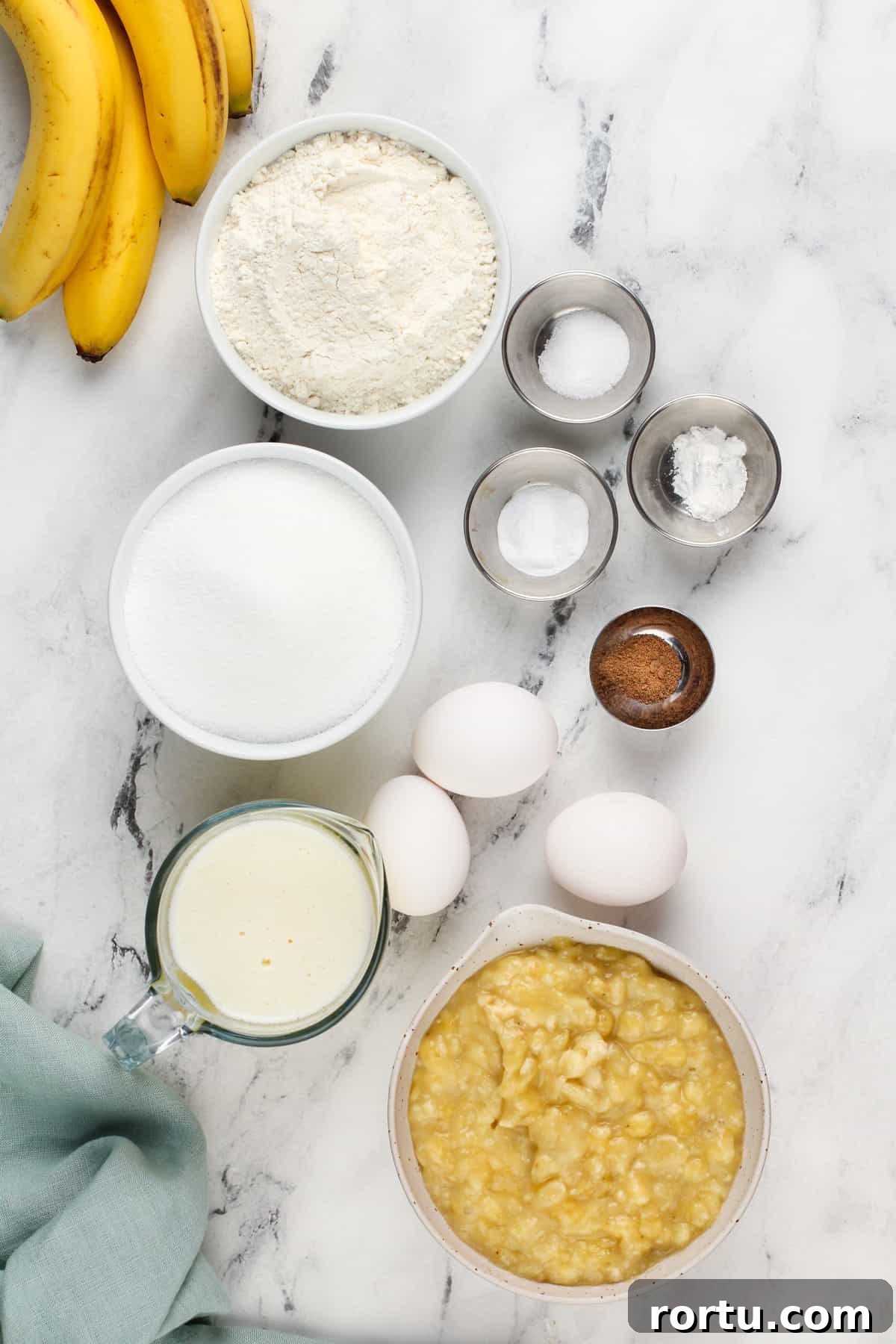 Ingredients for dominique ansel's banana bread arranged on a marble countertop.