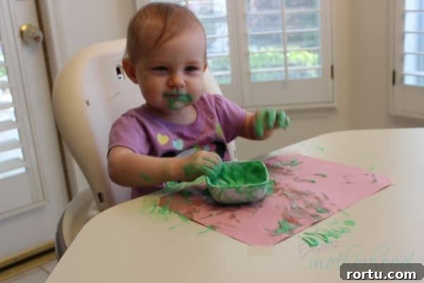 Young girl after playing with edible yogurt finger paint, pre-cleanup