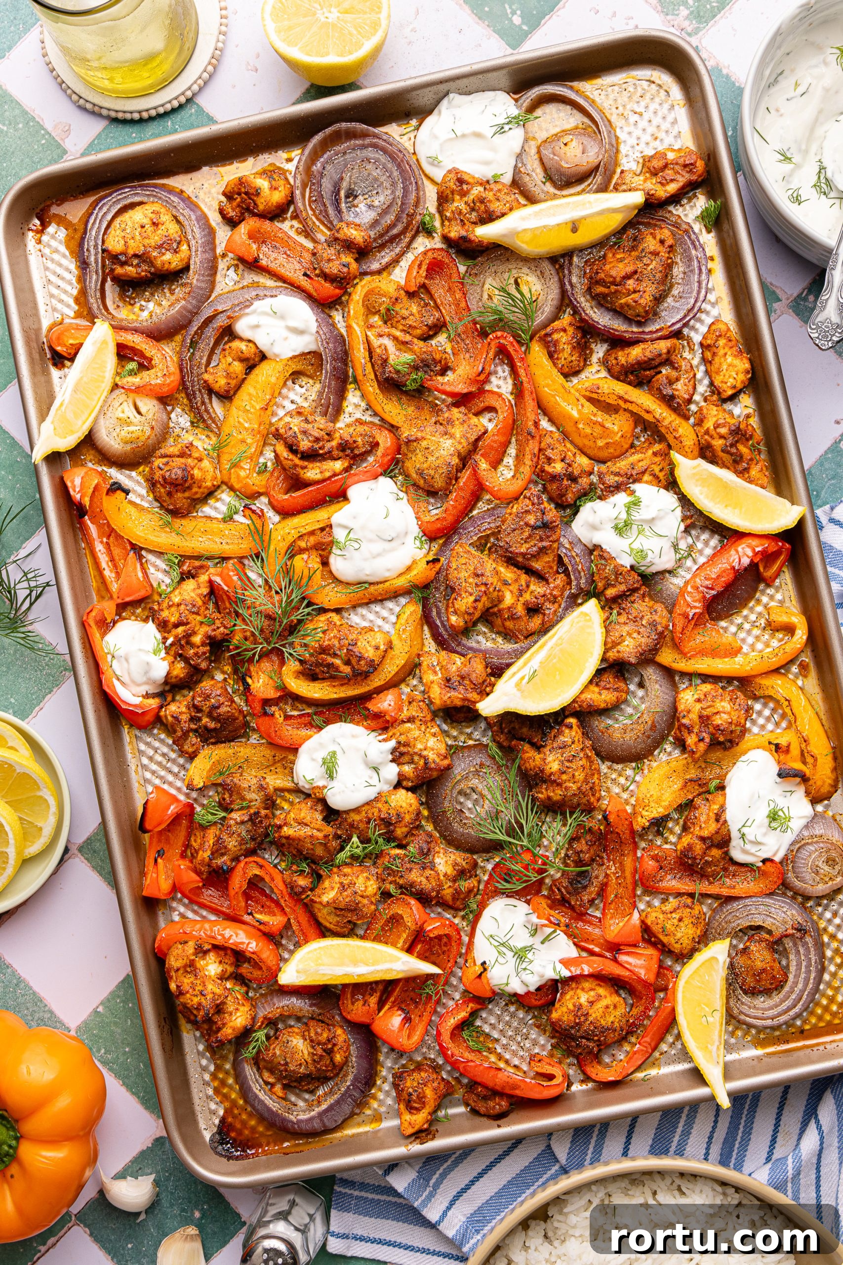 Mediterranean Sheet Pan Chicken with Lemon Garlic Yogurt Sauce 13 A Mediterranean Chicken sheet pan dinner made with yogurt marinated chicken, sliced bell peppers and onions topped with dollops of lemon-garlic yogurt sauce and fresh dill