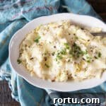 Colcannon Recipe: Traditional Irish Mashed Potatoes with Cabbage 5 A bowl of colcannon Irish mashed potatoes topped with melted butter, parsley and coarse black pepper.